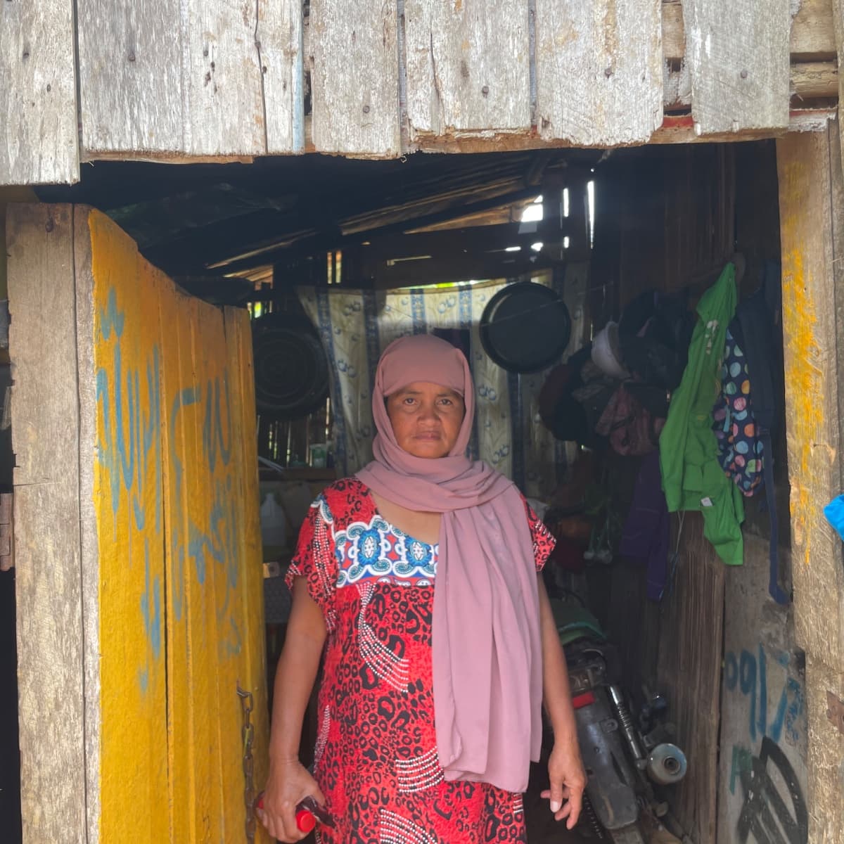 Rosaly, 48, stands outside her home in Papandayan, Marawi City.
