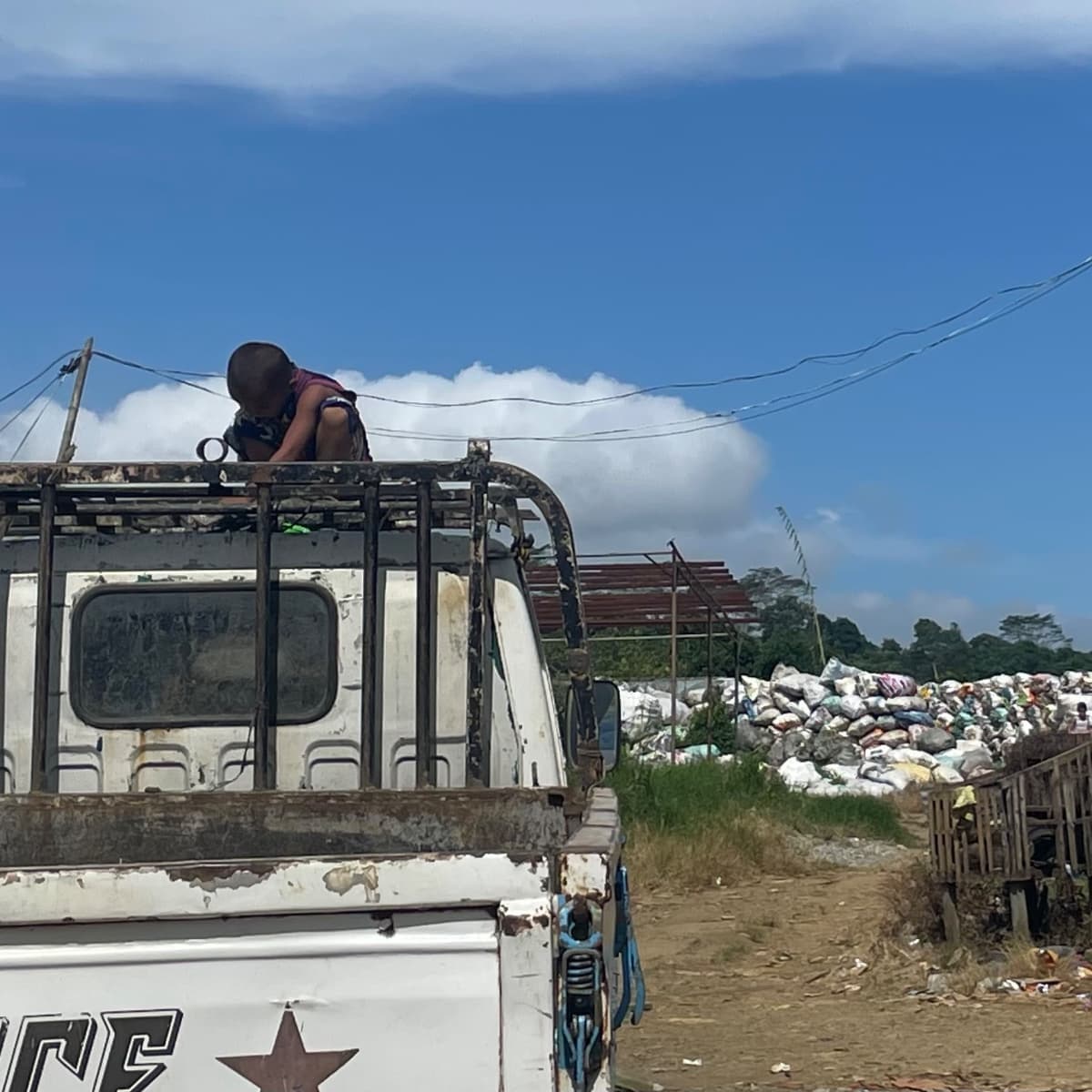 A child sits atop a truck near the Papandayan waste site.